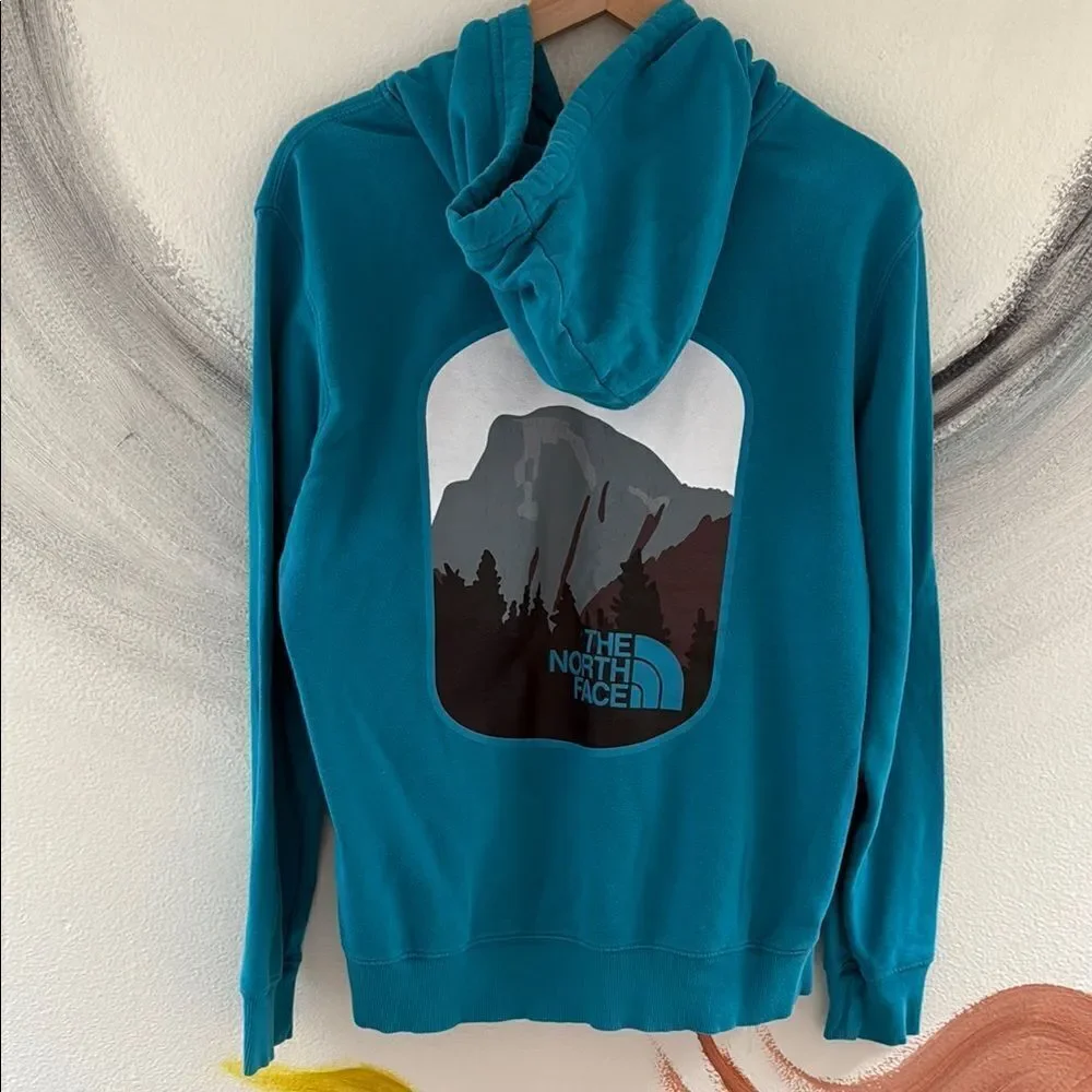 The North Face Men's Blue Hoodie. Size Medium. Drawstring hood.
